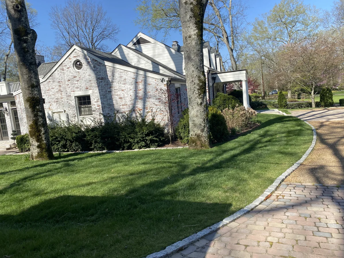 Lush Green Lawn Surrounding Large Brick Home in Belle Meade — Mr. Lawn Care, Middle Tennessee lawn treatment