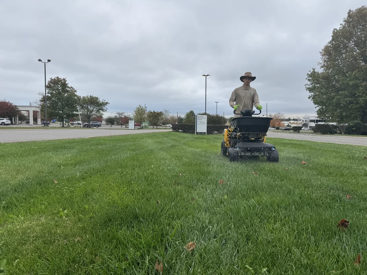 Landscaper Using Broadcast Spreader Sprayer on Green Lawn — Mr. Lawn Care, Middle Tennessee lawn treatment