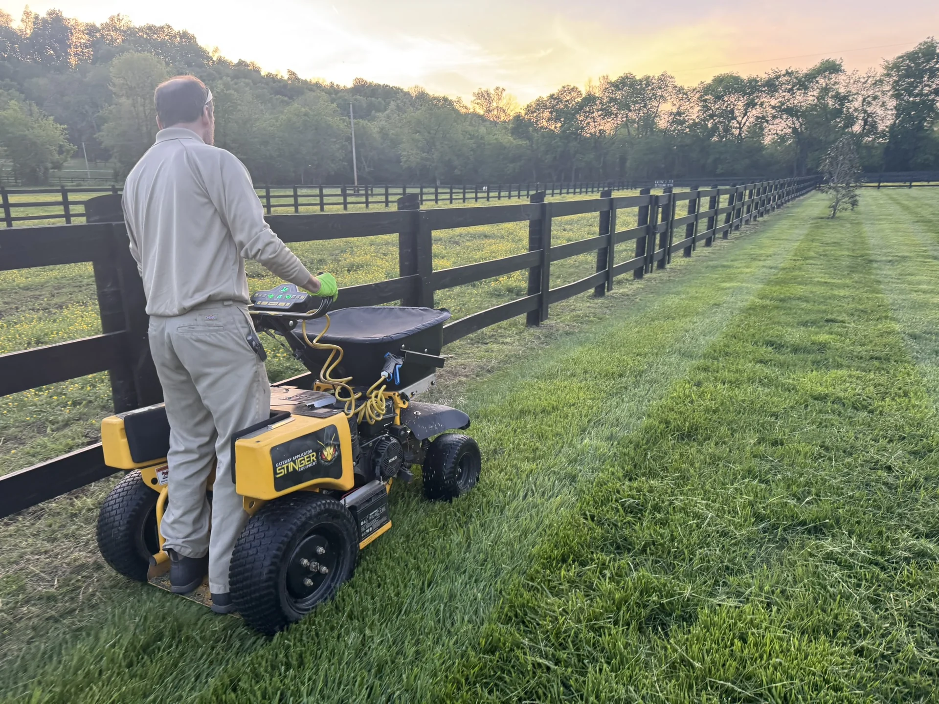 Our Horticulturist Applying a Treatment to a Beautiful Fescue Lawn in Culleoka a Nice Pasture on One Side and Fescue on the Other Closer up — Mr. Lawn Care, Middle Tennessee lawn treatment