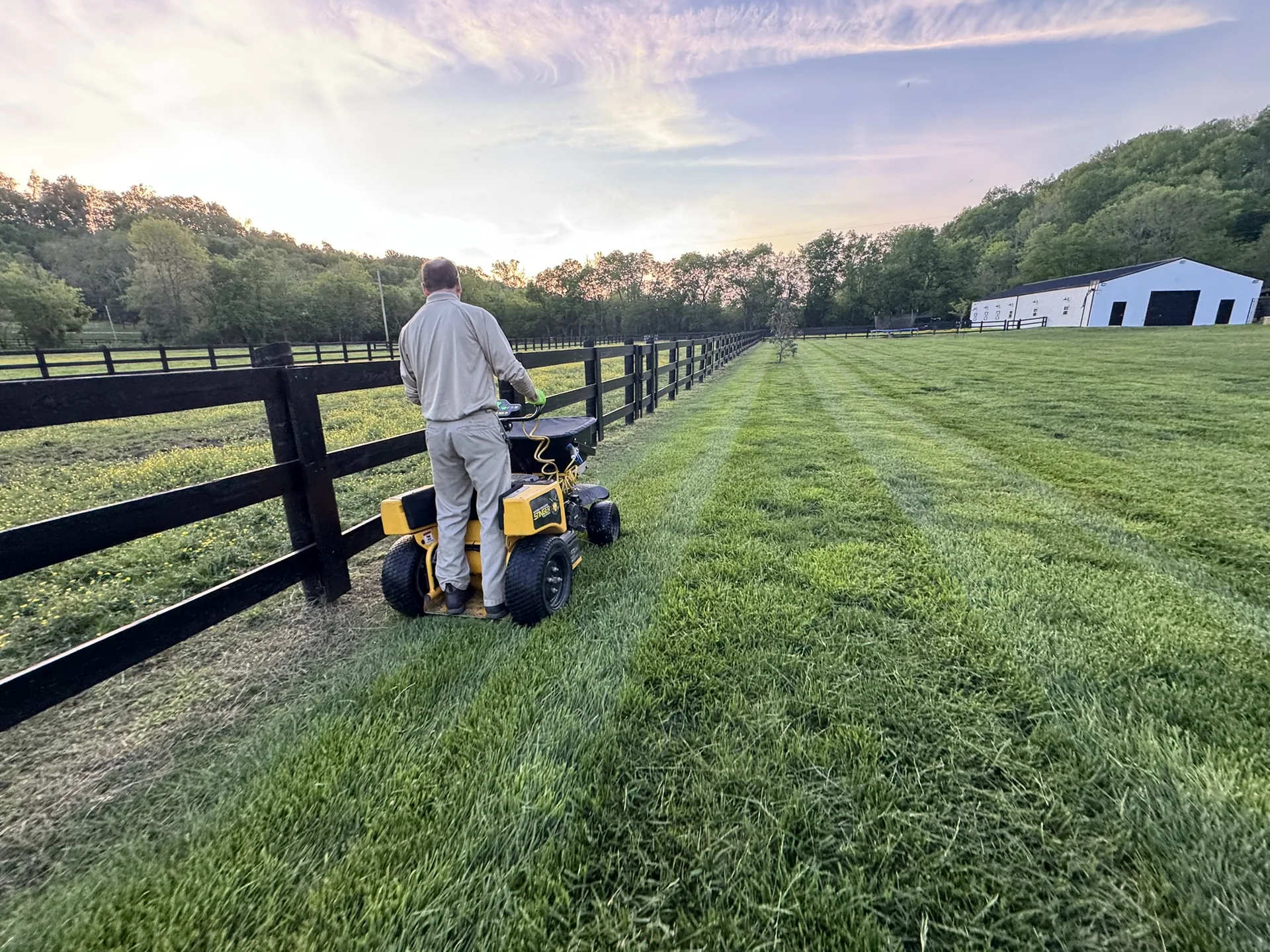 Our Horticulturist Applying a Treatment to a Beautiful Fescue Lawn in Culleoka a Nice Pasture on One Side and Fescue on the Other Farther Away You Can See the Barn in the Background — Mr. Lawn Care, Middle Tennessee lawn treatment
