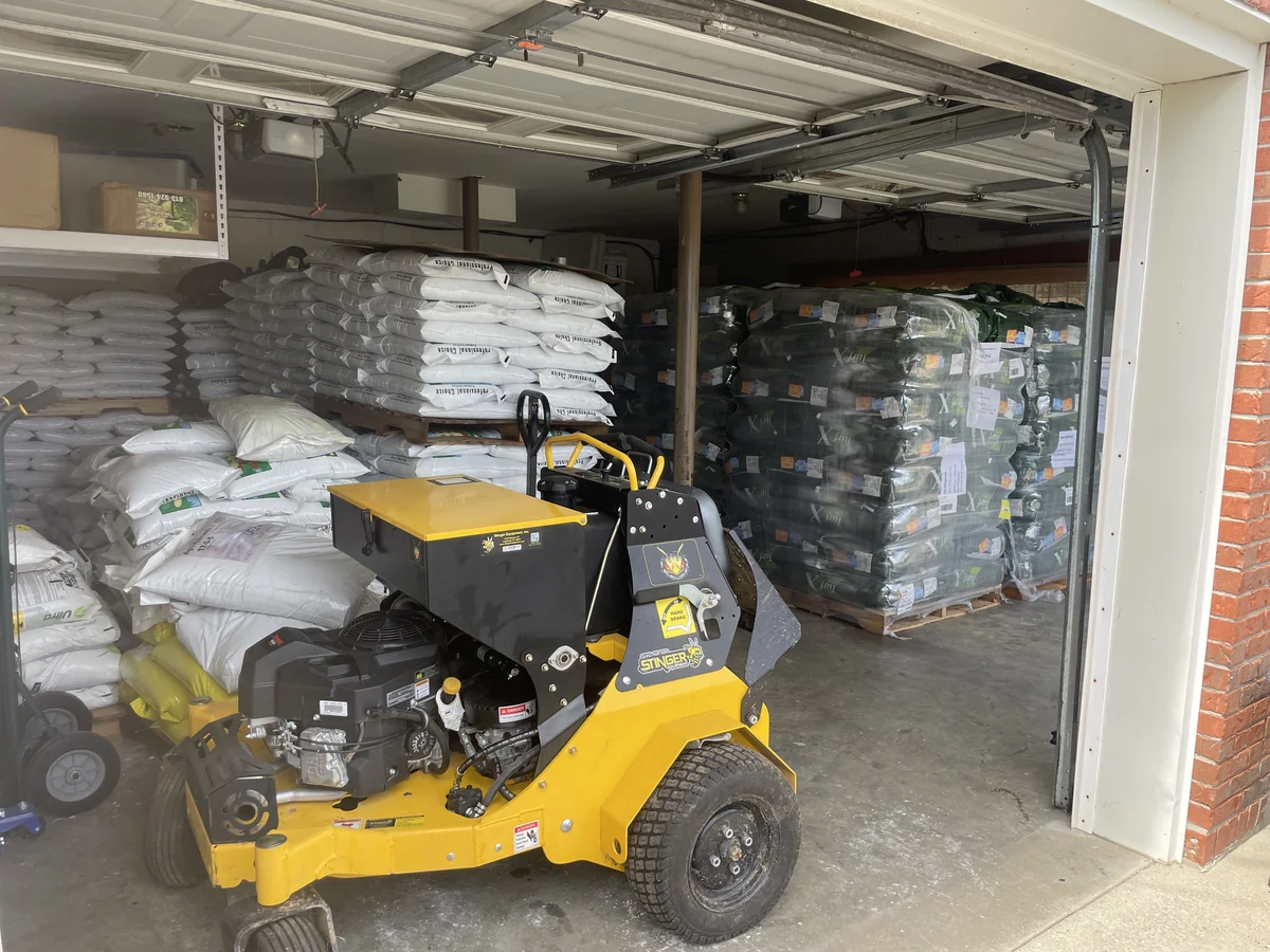 Yellow Singer Quad Aer Aerator Seeder Pallets of Seed Fertilizer in Columbia — Mr. Lawn Care, Middle Tennessee lawn treatment